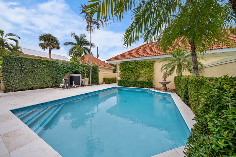 Outdoor patio pool with stone fountain